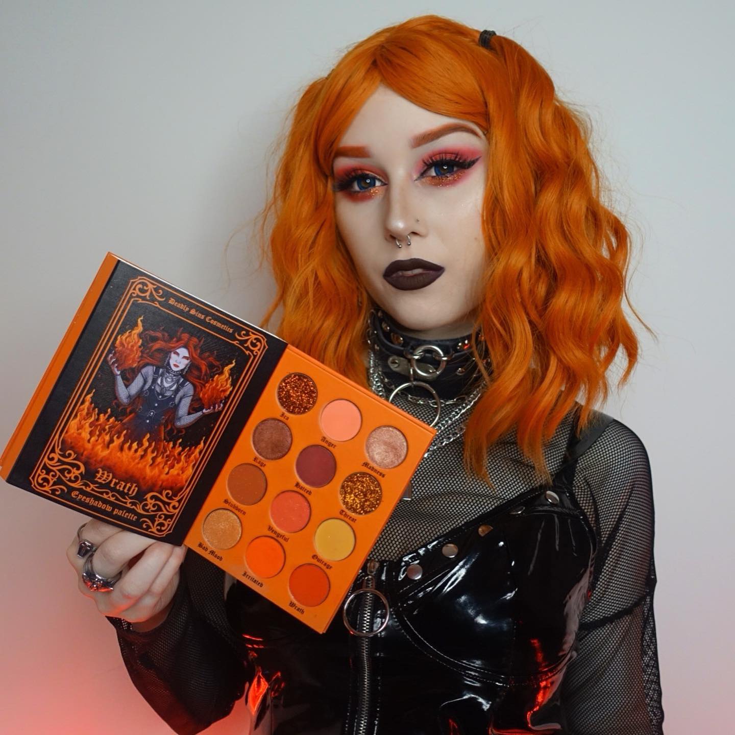Wrath Orange and Red Eyeshadow Palette Deadly Sins Cosmetics Australian Gothic makeup girl holding makeup palette